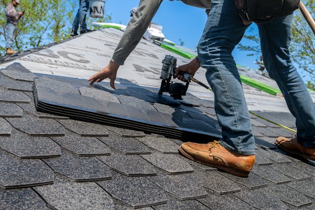 roofer installing new shingles
